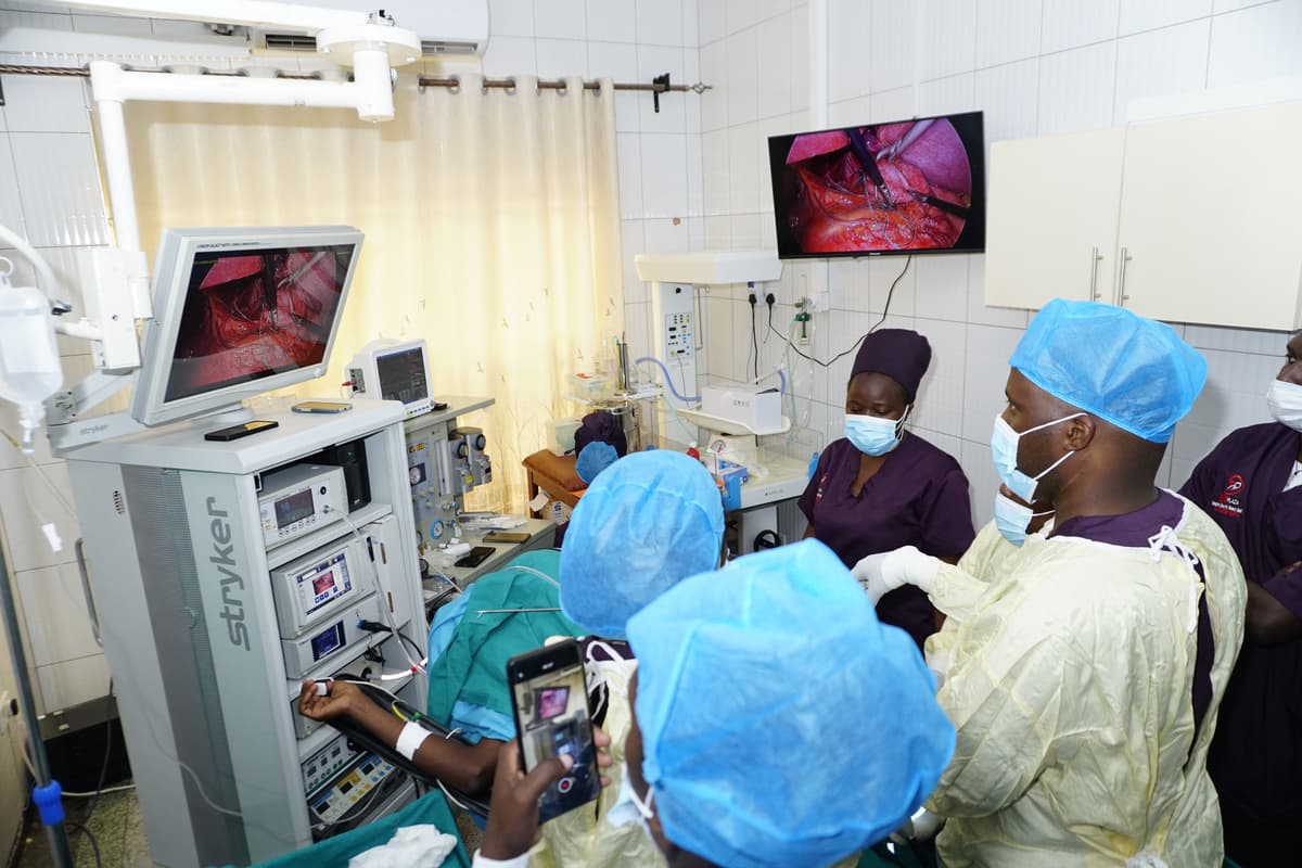 A healthcare team at Sikyomu using a phone during a procedure