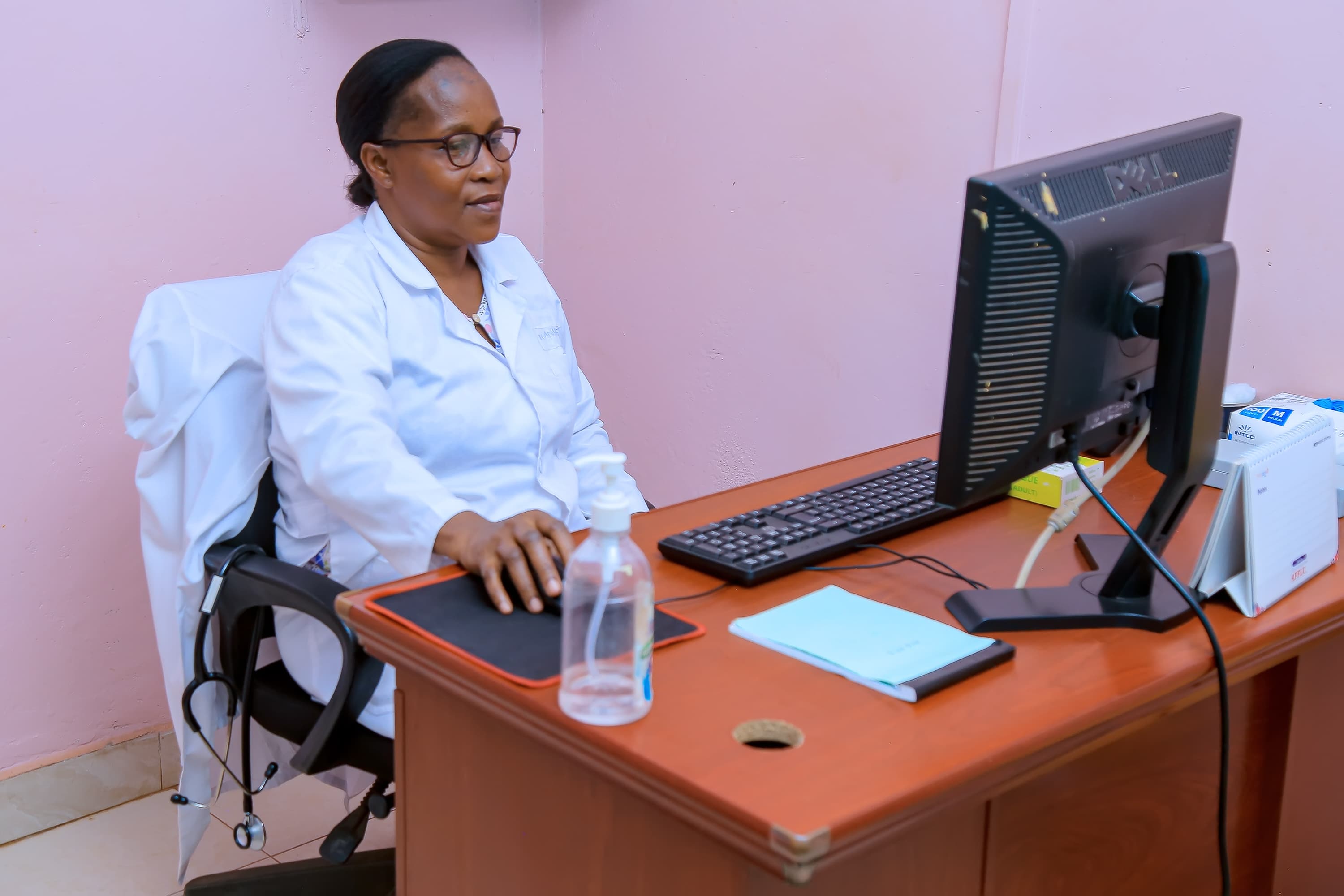 Doctor consulting with a smiling patient at Sikyomu Doctors Hospital